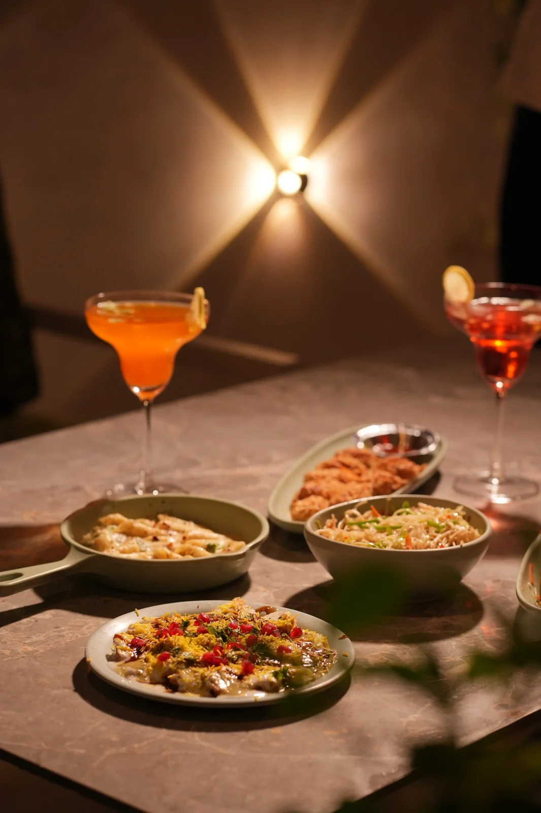 A cafe table with pasta, noodles, chaat, snacks and drinks. Nasha Chai Sutra, SFS Mansarovar Jaipur.