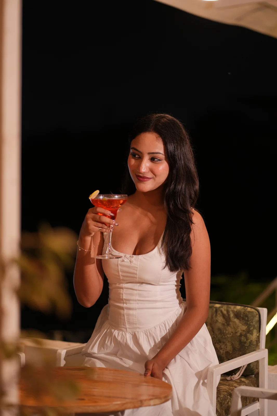 A guest seated at a table with food and a colourful drink. Nasha Chai Sutra, SFS Mansarovar Jaipur.
